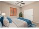 Cozy bedroom featuring a ceiling fan, window with shutters and double door closet at 6936 E Snowdon St, Mesa, AZ 85207