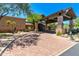 Elegant entry with a stone portico, circular paver driveway, and lush landscaping at 6936 E Snowdon St, Mesa, AZ 85207