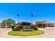 Entrance to Bozey's Golf Club with its flags, rock monuments and manicured foliage at 6936 E Snowdon St, Mesa, AZ 85207