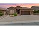 Charming single-story home features a tile roof, stone accents and a two car garage at 6936 E Snowdon St, Mesa, AZ 85207