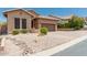 Charming home featuring a well-manicured front yard and private two-car garage at 6936 E Snowdon St, Mesa, AZ 85207