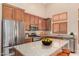 Modern kitchen with stainless steel appliances, granite countertops, and custom wood cabinets at 6936 E Snowdon St, Mesa, AZ 85207