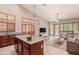 Open-concept kitchen and living area with high ceilings and stylish fixtures at 6936 E Snowdon St, Mesa, AZ 85207