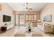 Bright living room with tile floors, modern decor, and lots of natural light at 6936 E Snowdon St, Mesa, AZ 85207
