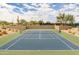 Well-maintained tennis court surrounded by desert landscaping at 6936 E Snowdon St, Mesa, AZ 85207