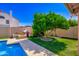 Backyard featuring a vibrant green tree with a charming playhouse for Gathering fun at 7725 W Dreyfus Dr, Peoria, AZ 85381