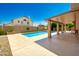 Backyard oasis with a sparkling pool and covered patio, perfect for relaxation and outdoor enjoyment at 7725 W Dreyfus Dr, Peoria, AZ 85381