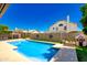 Inviting backyard with sparkling pool, lush artificial grass, and a charming playhouse for outdoor enjoyment at 7725 W Dreyfus Dr, Peoria, AZ 85381