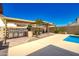 Backyard with a built-in outdoor kitchen under a pergola, ideal for hosting and dining al fresco at 7725 W Dreyfus Dr, Peoria, AZ 85381