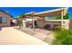 Backyard with a covered patio featuring an outdoor kitchen, great for outdoor entertaining at 7725 W Dreyfus Dr, Peoria, AZ 85381