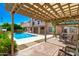 Backyard featuring a covered patio and a pool, ideal for relaxing or entertaining guests at 7725 W Dreyfus Dr, Peoria, AZ 85381