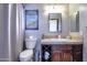 Cozy bathroom features a toilet, vanity with storage, and a shower with a curtain at 7725 W Dreyfus Dr, Peoria, AZ 85381