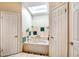 Bright bathroom features a soaking tub beneath a skylight and decorative tile accents at 7725 W Dreyfus Dr, Peoria, AZ 85381