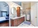 Bathroom boasting double sinks, a glass-enclosed shower, and modern lighting fixtures at 7725 W Dreyfus Dr, Peoria, AZ 85381