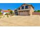 Charming two-story home with desert landscaping and a long private driveway to the attached two car garage at 7725 W Dreyfus Dr, Peoria, AZ 85381