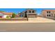 Charming two-story home with desert landscaping and a long private driveway to the attached two car garage at 7725 W Dreyfus Dr, Peoria, AZ 85381