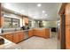 Well-lit kitchen with stainless steel appliances, granite countertops, and ample cabinet space at 7725 W Dreyfus Dr, Peoria, AZ 85381