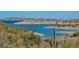 Scenic view of a lake with cactus and desert landscape, highlighting the natural beauty at 7725 W Dreyfus Dr, Peoria, AZ 85381