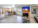 Inviting living space with fireplace, French doors to backyard, and bar seating to kitchen at 7725 W Dreyfus Dr, Peoria, AZ 85381