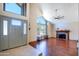 Inviting living room with hardwood floors, a fireplace, and a grand entrance at 7725 W Dreyfus Dr, Peoria, AZ 85381