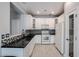 Well-lit kitchen with white cabinetry, black countertops, and stainless steel appliances at 813 E Agua Fria Ln, Avondale, AZ 85323