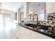 Modern kitchen featuring dark countertops, white cabinets, and mosaic backsplash at 813 E Agua Fria Ln, Avondale, AZ 85323
