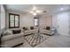 Comfortable living room features a ceiling fan, neutral tones, and tiled floors at 813 E Agua Fria Ln, Avondale, AZ 85323