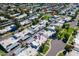 An aerial view showing the neighborhood homes and community pools with mature trees and greenery at 8341 E Keim Dr, Scottsdale, AZ 85250
