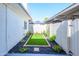 A beautifully landscaped backyard features artificial turf and vibrant flowers creating a serene outdoor space at 8341 E Keim Dr, Scottsdale, AZ 85250