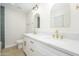 Bathroom featuring a dual sink vanity, white marble countertop, and elegant gold fixtures at 8341 E Keim Dr, Scottsdale, AZ 85250