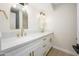 Bathroom with dual sink vanity, white marble countertop, and gold fixtures at 8341 E Keim Dr, Scottsdale, AZ 85250