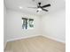 Bright bedroom with wood flooring and a ceiling fan at 8341 E Keim Dr, Scottsdale, AZ 85250