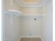 Walk-in closet with white shelving and laminate floor at 8341 E Keim Dr, Scottsdale, AZ 85250