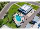 Aerial view of the community pool featuring lounge chairs, umbrellas, a clubhouse, and mature landscaping at 8341 E Keim Dr, Scottsdale, AZ 85250