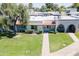 Charming single-story home with a well-manicured front lawn and a pathway leading to the entrance with an arched patio at 8341 E Keim Dr, Scottsdale, AZ 85250