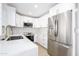Bright kitchen features new stainless steel appliances, white cabinets, and gold hardware at 8341 E Keim Dr, Scottsdale, AZ 85250