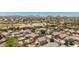 Aerial view of neighborhood with desert landscaping and community pool at 878 E Mountain View Rd, San Tan Valley, AZ 85143