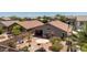 This aerial view shows a backyard with a patio area with lounge, desert landscaping, and seating at 878 E Mountain View Rd, San Tan Valley, AZ 85143