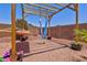Backyard features pergola with hanging hammocks surrounded by desert landscaping at 878 E Mountain View Rd, San Tan Valley, AZ 85143