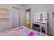 Bedroom with a lighted vanity mirror and closet doors at 878 E Mountain View Rd, San Tan Valley, AZ 85143