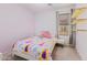 Bright bedroom with a bed with a princess-themed bedspread and shelves at 878 E Mountain View Rd, San Tan Valley, AZ 85143