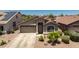 Single-story home features a front yard, two car garage, and desert landscaping at 878 E Mountain View Rd, San Tan Valley, AZ 85143