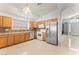 Bright kitchen featuring stainless steel appliances, wood cabinetry, and tile floors at 878 E Mountain View Rd, San Tan Valley, AZ 85143