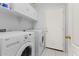 Laundry room with white washer and dryer, cabinets and white door at 878 E Mountain View Rd, San Tan Valley, AZ 85143