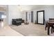 Open living space with carpet flooring, natural light, a large mirror, and comfortable seating at 878 E Mountain View Rd, San Tan Valley, AZ 85143