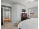 Main bedroom with a dresser, TV, and access to the ensuite bathroom at 878 E Mountain View Rd, San Tan Valley, AZ 85143