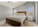 Main bedroom with a king-sized bed and natural light at 878 E Mountain View Rd, San Tan Valley, AZ 85143
