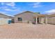 Gravel backyard showing exterior walls, covered patio, and exterior door at 9261 W Sheridan St, Phoenix, AZ 85037