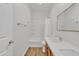 Well-lit bathroom with wood-look flooring, tub, and granite counters at 9261 W Sheridan St, Phoenix, AZ 85037