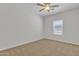 Bedroom with a lighted ceiling fan and large window at 9261 W Sheridan St, Phoenix, AZ 85037